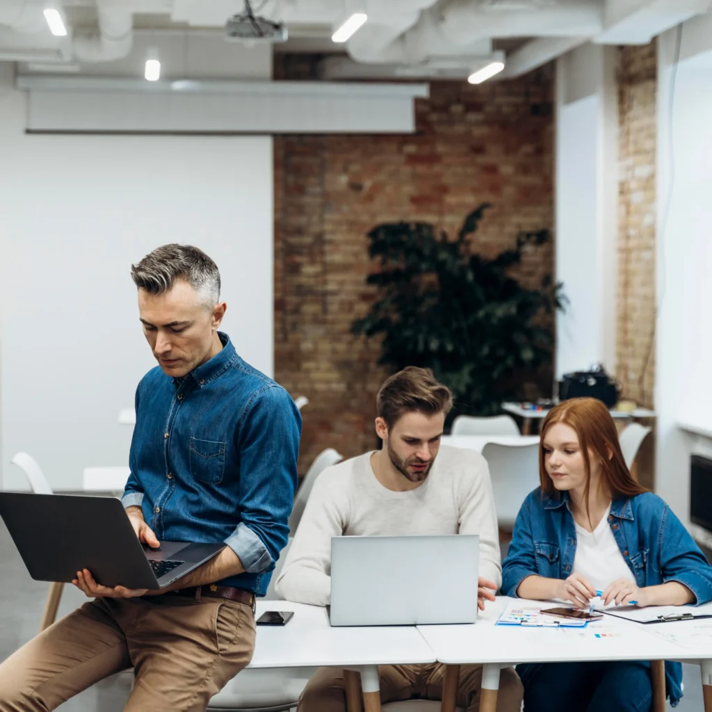 Coworkers discussing business project indoors